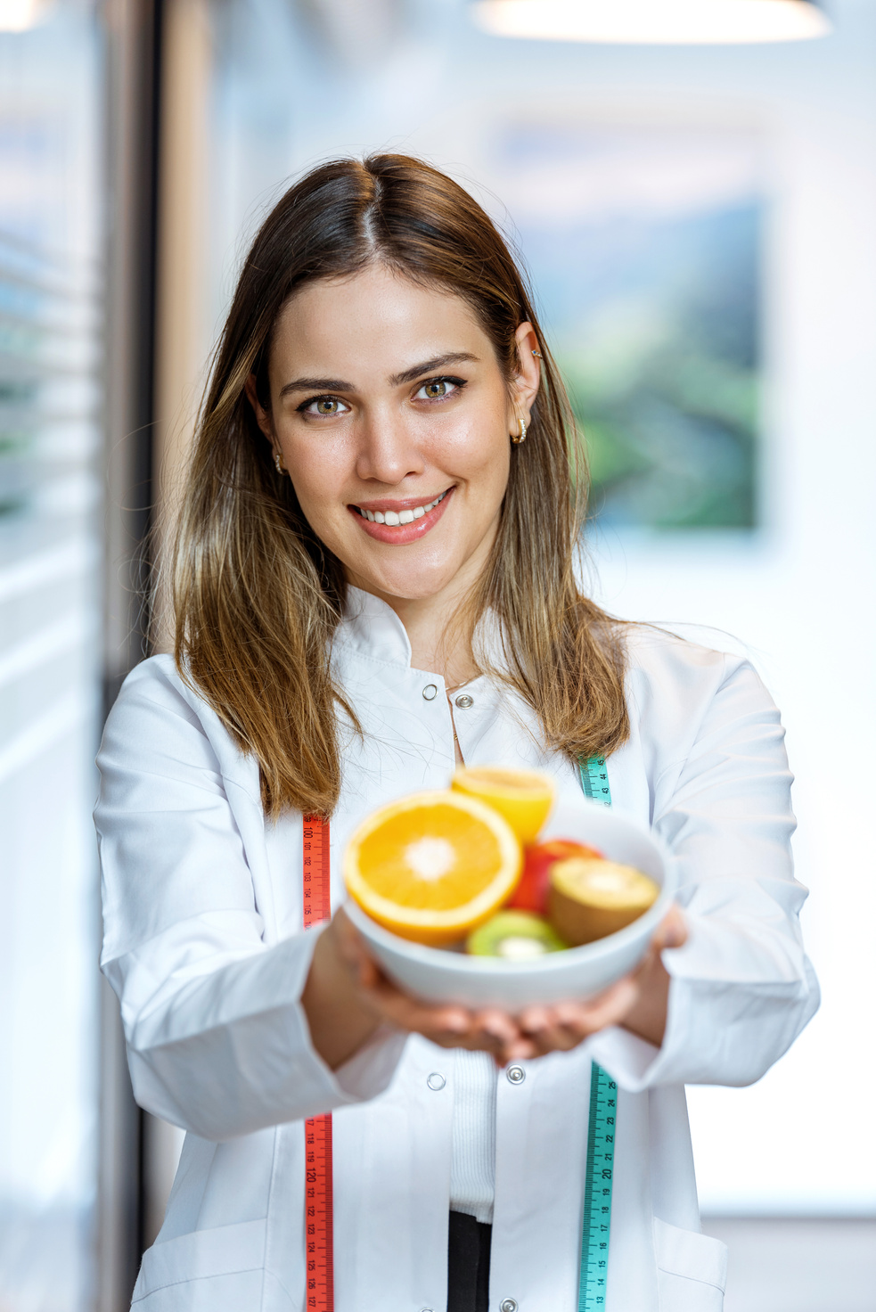 Female nutritionist doctor hands holding fruits